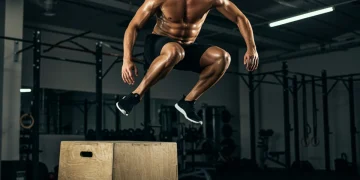 Athlete performing a powerful box jump, demonstrating plyometric explosive power.