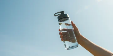 Expert Tips: 8 Hydration Strategies for 2025 Summer Heat Person staying hydrated with water bottle in summer heat