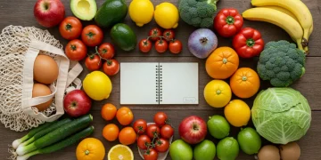 Colorful seasonal fruits and vegetables with reusable bags, symbolizing sustainable eating and grocery savings.